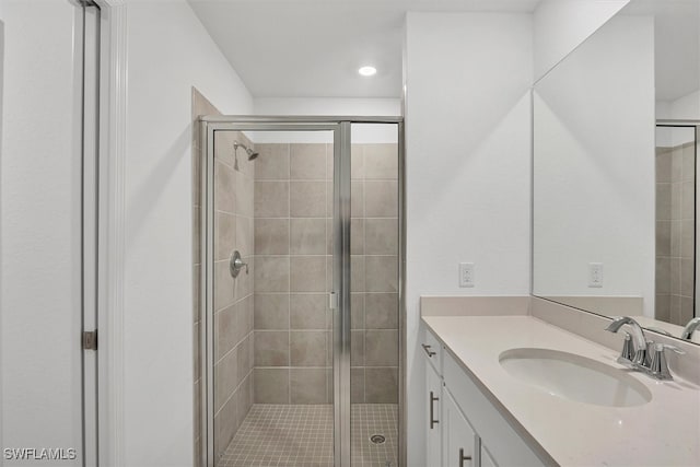 bathroom with vanity and an enclosed shower