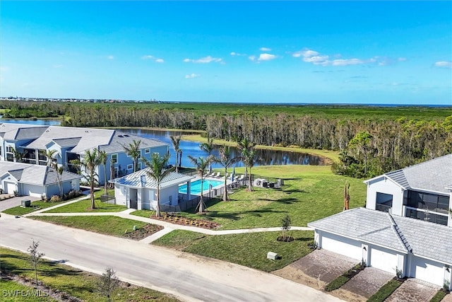 birds eye view of property with a water view