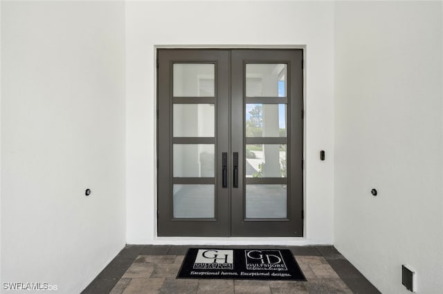 view of exterior entry featuring french doors