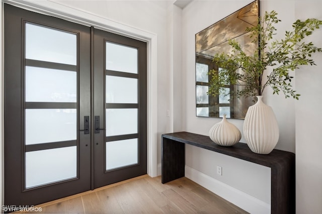 doorway to outside with french doors and light hardwood / wood-style flooring