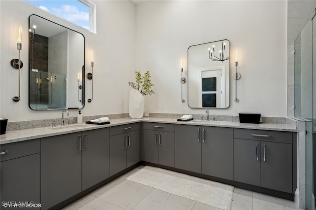 bathroom with a shower with door, vanity, and a notable chandelier