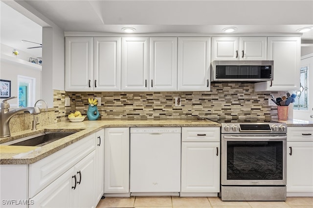 kitchen featuring white cabinets, light tile patterned flooring, sink, and stainless steel appliances