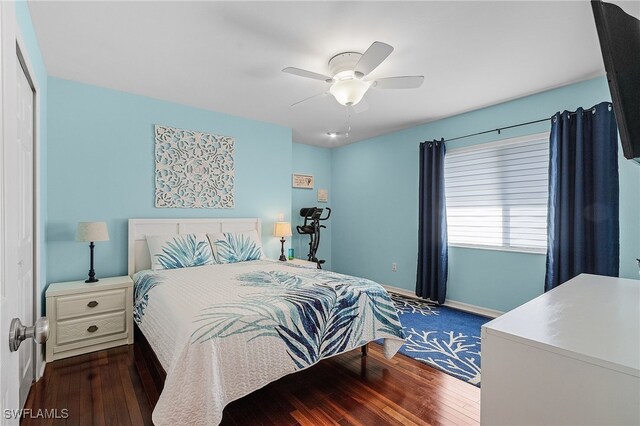 bedroom with ceiling fan, a closet, and dark wood-type flooring