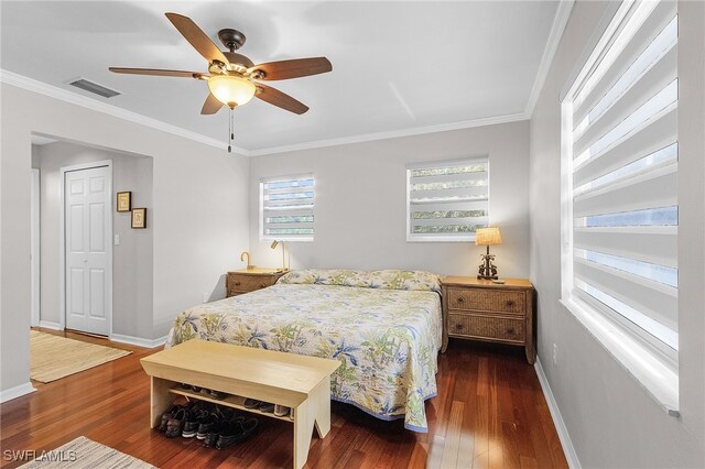 bedroom featuring ceiling fan, dark hardwood / wood-style floors, and ornamental molding