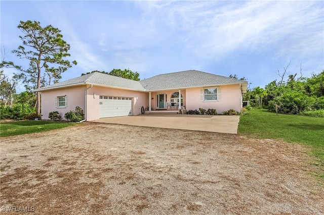 ranch-style house featuring a garage and a front lawn