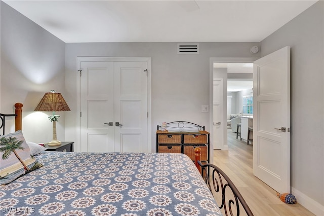 bedroom featuring light hardwood / wood-style floors and a closet