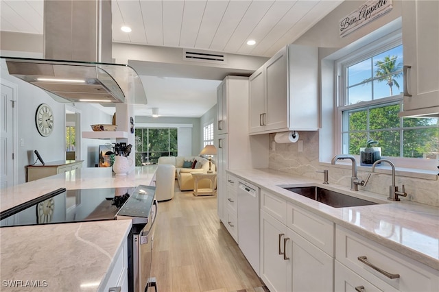 kitchen with sink, dishwasher, island exhaust hood, stainless steel electric stove, and white cabinets