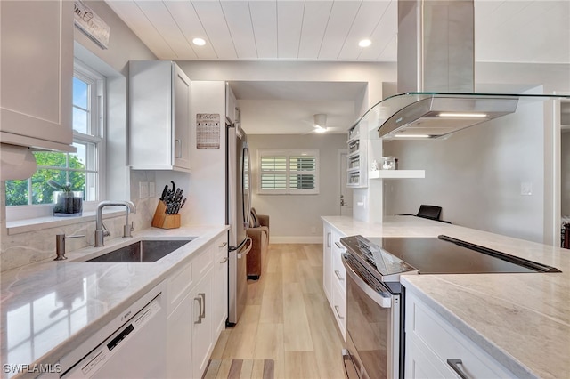 1051 3rd St S Unit 201, Naples, FL 34102 - kitchen with island range hood, appliances with stainless steel finishes, a sink, light wood-style flooring, and plenty of natural light