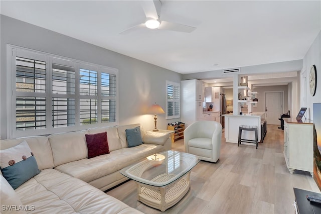 living room with ceiling fan and light wood-type flooring