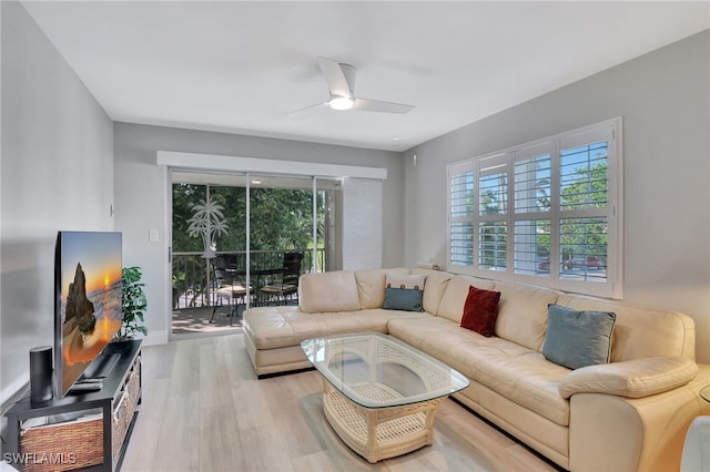 living room featuring light hardwood / wood-style flooring and ceiling fan