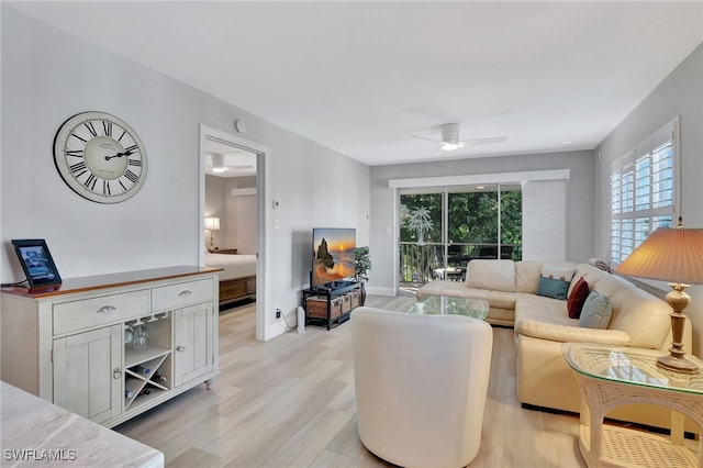 living room with ceiling fan and light wood-type flooring