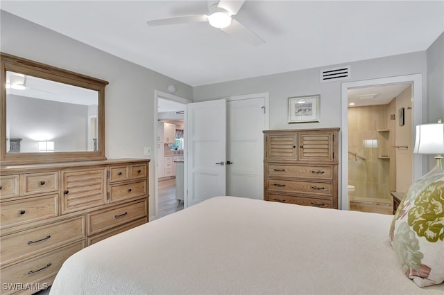 bedroom featuring a closet, ceiling fan, and ensuite bathroom