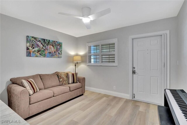 living room with ceiling fan and light hardwood / wood-style flooring