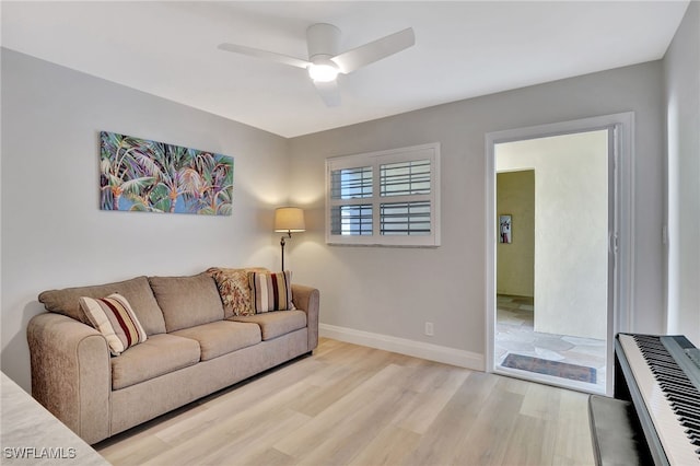 living room featuring ceiling fan and light hardwood / wood-style flooring