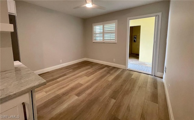 interior space with ceiling fan and light hardwood / wood-style floors