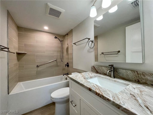 full bathroom with vanity, toilet, and tiled shower / bath combo