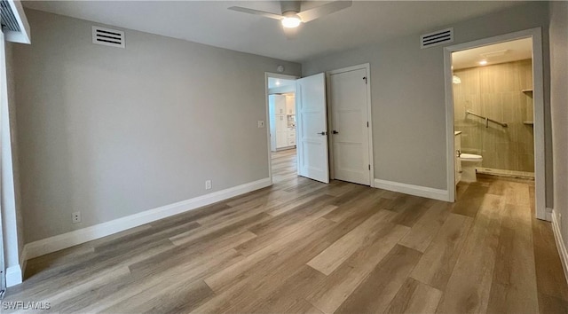 unfurnished bedroom featuring ensuite bathroom, ceiling fan, and light wood-type flooring