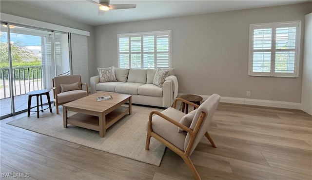 1051 3rd St S Unit 201, Naples, FL 34102 - living area with plenty of natural light, a ceiling fan, light wood finished floors, and baseboards