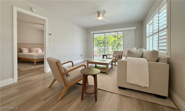 1051 3rd St S Unit 201, Naples, FL 34102 - living area featuring light wood finished floors, a ceiling fan, and baseboards