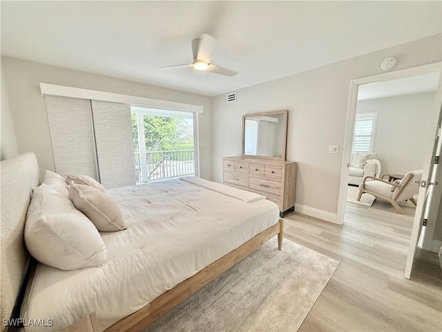 1051 3rd St S Unit 201, Naples, FL 34102 - bedroom featuring multiple windows, light wood-type flooring, a ceiling fan, and baseboards