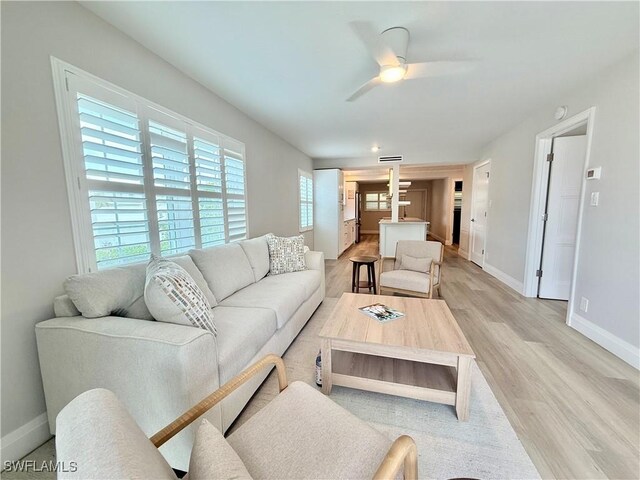 1051 3rd St S Unit 201, Naples, FL 34102 - living area featuring baseboards, ceiling fan, and light wood-style flooring