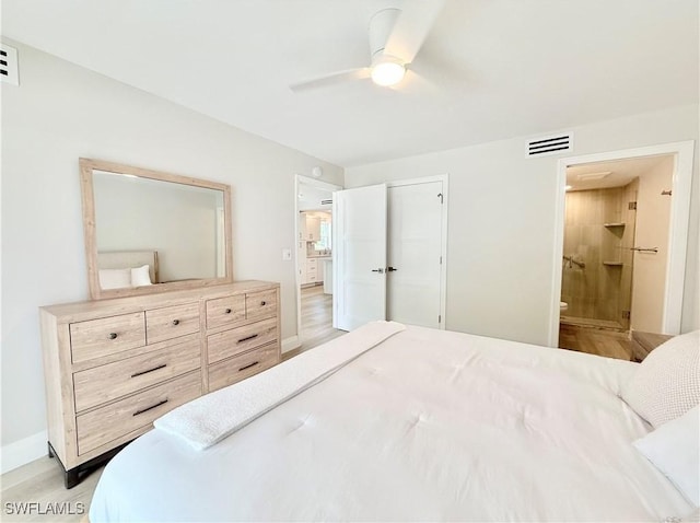 1051 3rd St S Unit 201, Naples, FL 34102 - bedroom featuring light wood-style floors, ensuite bath, a ceiling fan, a closet, and baseboards