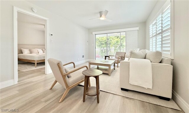 1051 3rd St S Unit 201, Naples, FL 34102 - living area featuring light wood-style flooring, ceiling fan, and baseboards