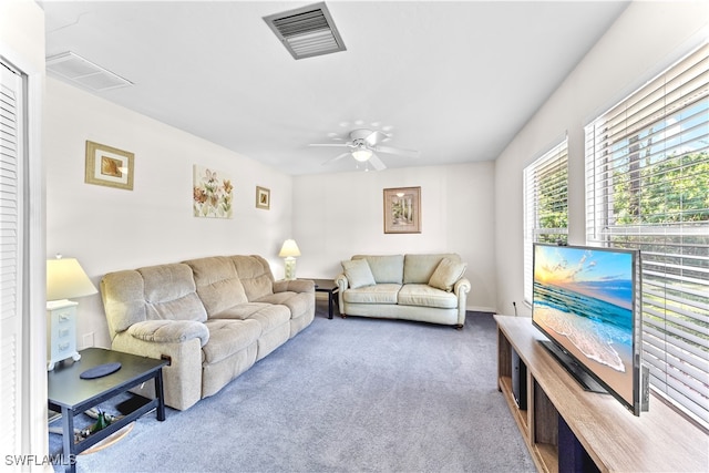 carpeted living room with ceiling fan