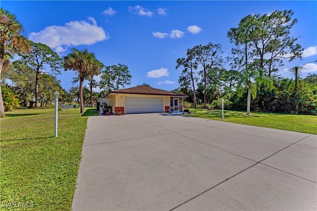 ranch-style house featuring a garage and a front yard