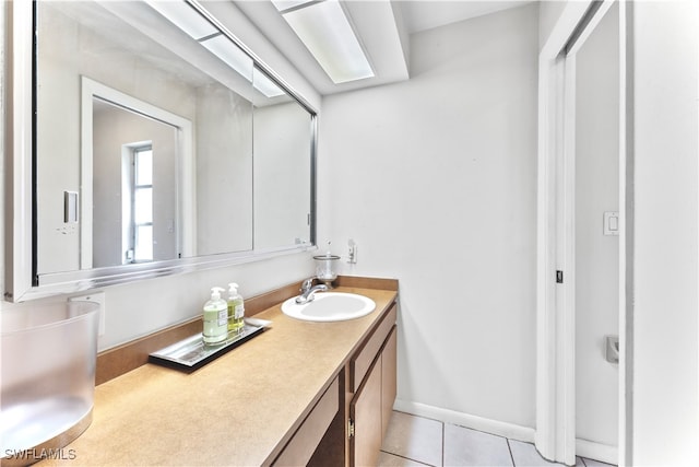 bathroom with tile patterned floors and vanity