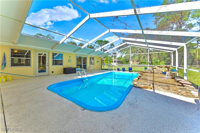 view of pool with a patio and glass enclosure