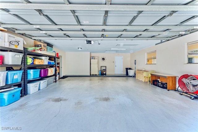 garage with white refrigerator and a garage door opener