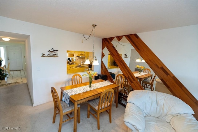 dining space with stairs and light colored carpet