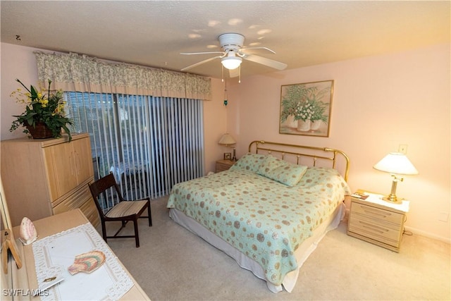 bedroom featuring baseboards, a textured ceiling, a ceiling fan, and carpet flooring