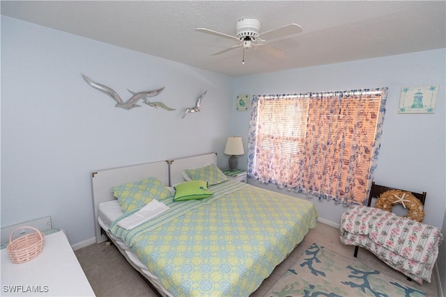 bedroom with ceiling fan, carpet, and baseboards