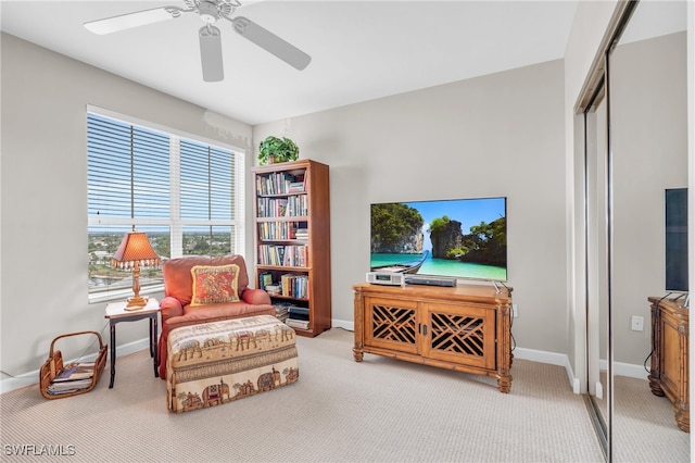 sitting room with carpet, ceiling fan, and a healthy amount of sunlight