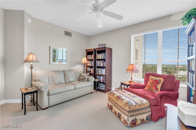 carpeted living room featuring ceiling fan