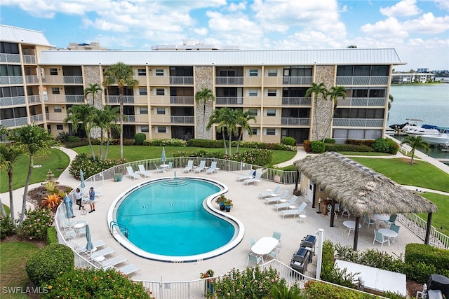 view of pool with a gazebo, a patio, and a water view