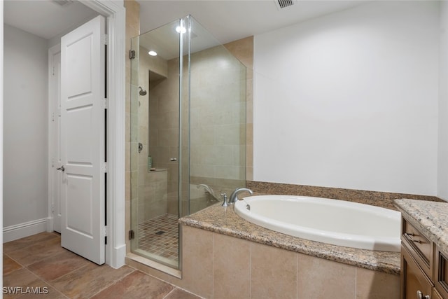 bathroom with tile patterned floors, plus walk in shower, and vanity