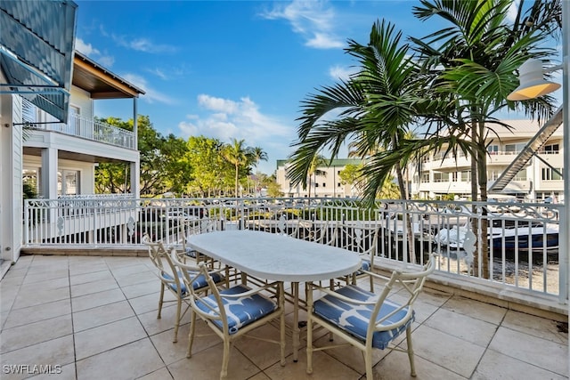 view of patio / terrace featuring a water view and a balcony