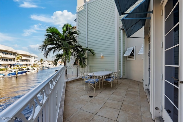 view of patio / terrace featuring a balcony and a water view