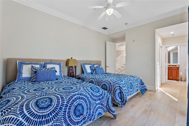 bedroom featuring wood-type flooring, ensuite bath, ceiling fan, and crown molding