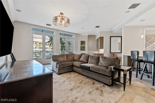 living room featuring ornamental molding and a chandelier