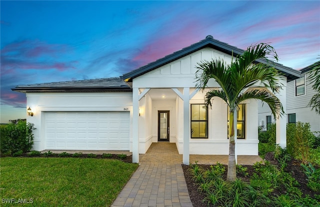 view of front of house featuring a lawn and a garage