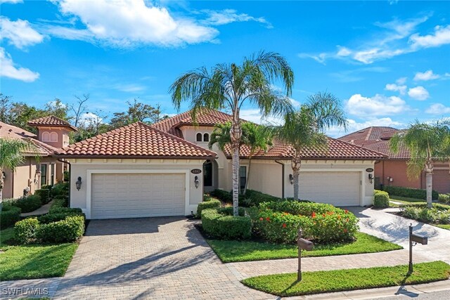 mediterranean / spanish-style house with a garage