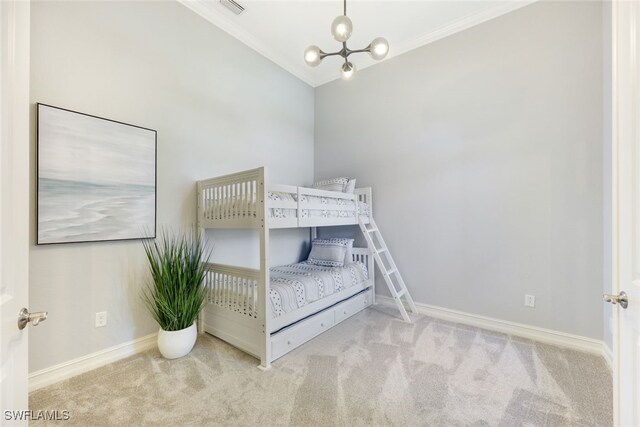 unfurnished bedroom featuring an inviting chandelier, light colored carpet, vaulted ceiling, and ornamental molding