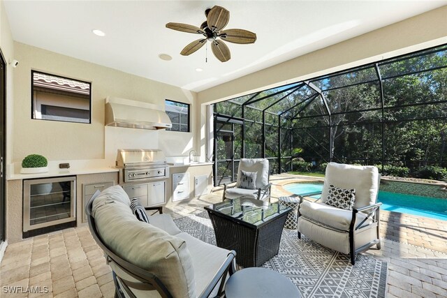 view of patio featuring an outdoor kitchen, an outdoor living space, glass enclosure, wine cooler, and a grill