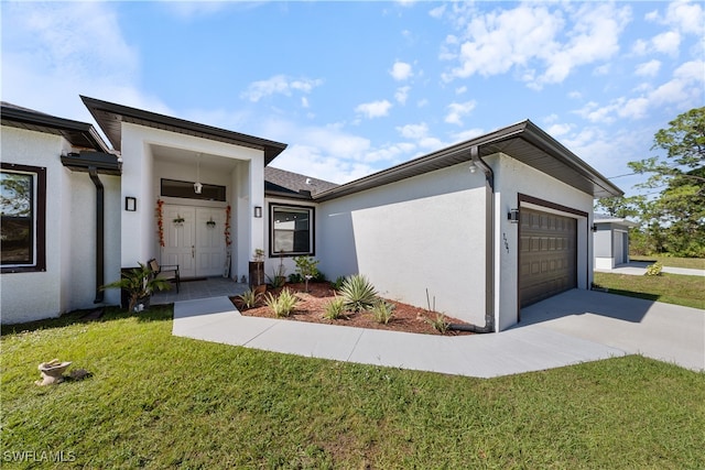 view of front of property featuring a garage and a front lawn