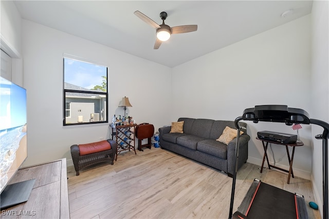 living room with ceiling fan and light hardwood / wood-style floors