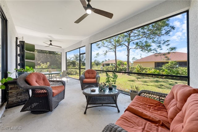 sunroom / solarium featuring ceiling fan